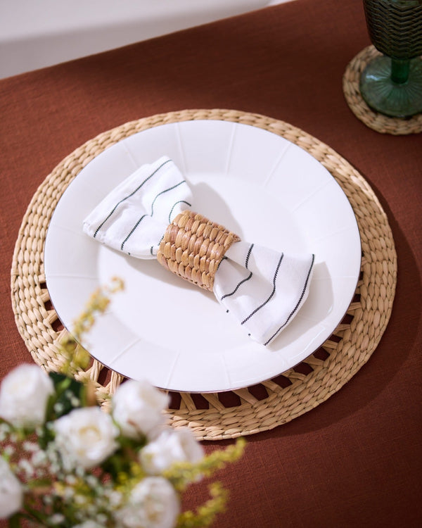 White napkin with black stripes in Kauna Grass rattan ring