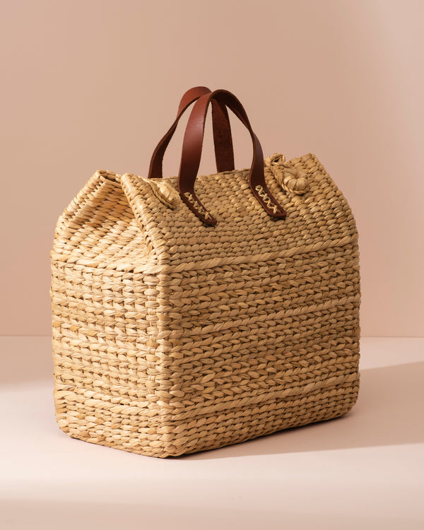 Large Kouna Grass Bag: beige woven straw tote with brown leather handles and knot detail