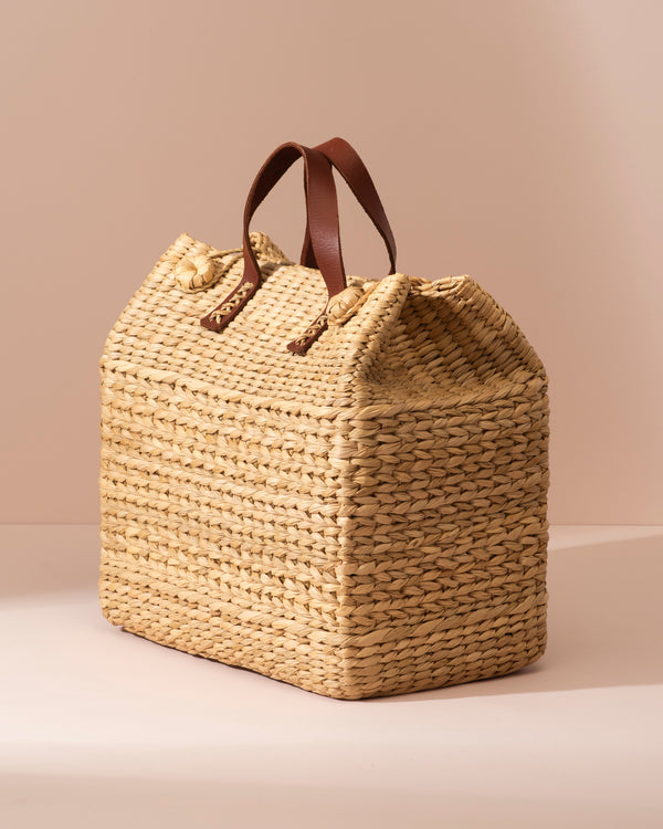 Large Kouna Grass Bag: beige woven straw tote with brown leather handles and wooden buttons