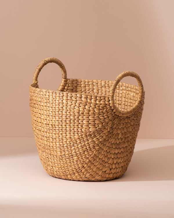 Medium water hyacinth storage basket with woven straw and rounded handles