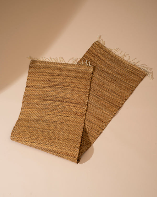 Natural water hyacinth table runner with woven jute texture and frayed edges, 122cm
