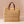 Large Kouna Grass Bag: beige woven straw tote with brown leather handles and knots