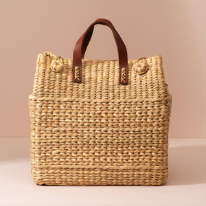 Large Kouna Grass Bag: beige woven straw tote with brown leather handles and knots