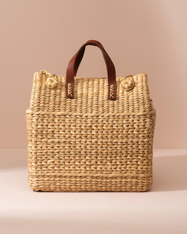 Large Kouna Grass Bag: beige woven straw tote with brown leather handles and knots