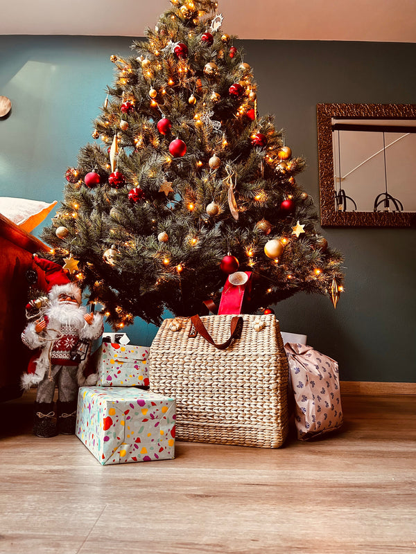 Tall decorated Christmas tree with red and gold ornaments on Kouna Grass Bag Large