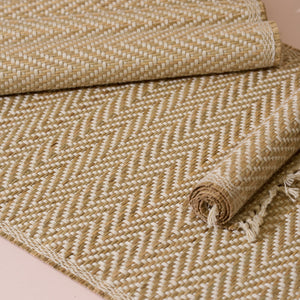 Beige and cream herringbone woven rug with fringed edges