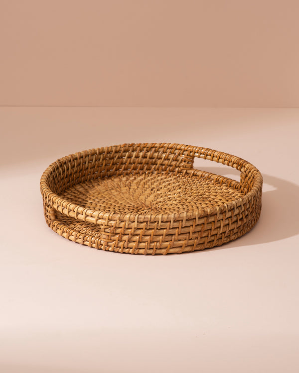 Round woven rattan tray in natural tan with integrated handles