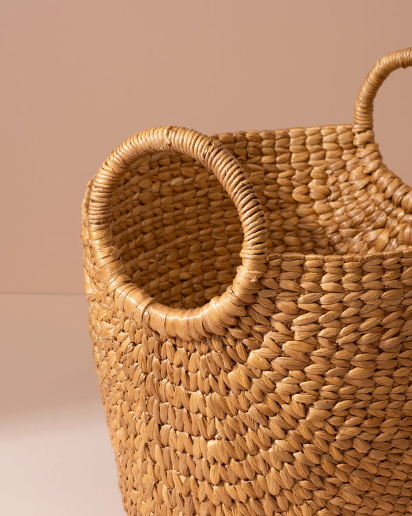 Medium water hyacinth storage basket with woven straw and rounded handles