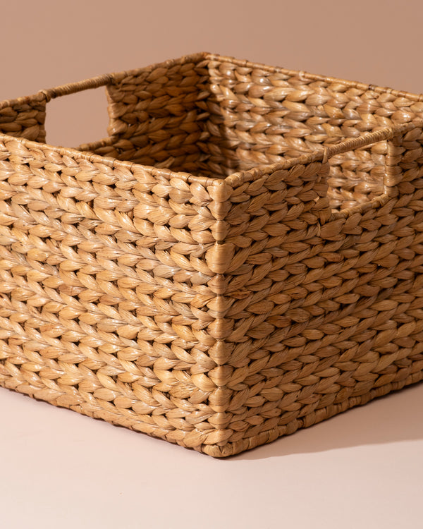 Medium water hyacinth storage basket with woven seagrass and braided handles