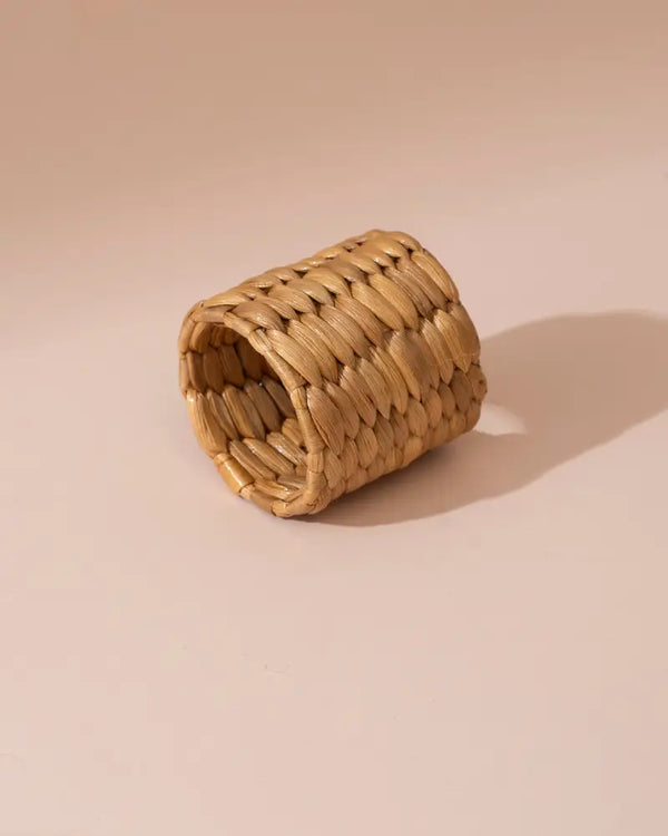 Handwoven beige water hyacinth napkin ring with textured interlaced pattern